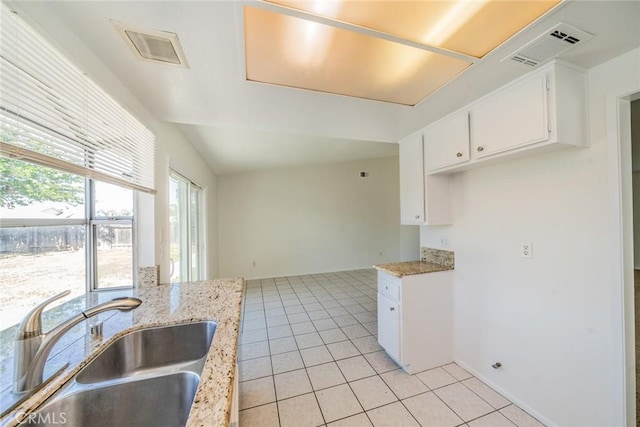 23607 Dracaea Ave, Moreno Valley, CA 92553 - kitchen featuring a sink, white cabinetry, light tile patterned floors, and light stone countertops