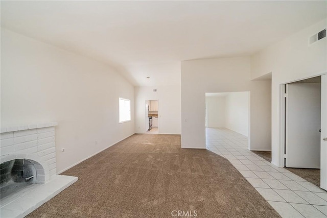 23607 Dracaea Ave, Moreno Valley, CA 92553 - unfurnished living room featuring light carpet, light tile patterned floors, and a fireplace