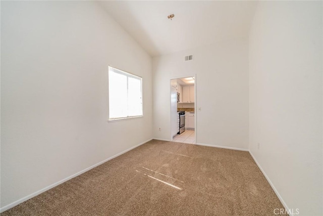 23607 Dracaea Ave, Moreno Valley, CA 92553 - empty room featuring light carpet, lofted ceiling, and baseboards