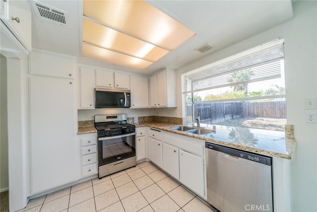23607 Dracaea Ave, Moreno Valley, CA 92553 - kitchen with stainless steel appliances, a sink, white cabinetry, and light tile patterned flooring