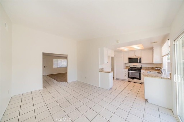 23607 Dracaea Ave, Moreno Valley, CA 92553 - kitchen featuring stainless steel appliances, white cabinetry, light tile patterned floors, light stone countertops, and open floor plan