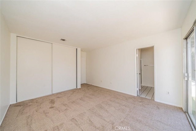 23607 Dracaea Ave, Moreno Valley, CA 92553 - unfurnished bedroom featuring carpet flooring, baseboards, connected bathroom, and a closet