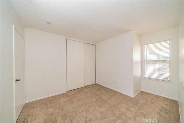 23607 Dracaea Ave, Moreno Valley, CA 92553 - unfurnished bedroom featuring light colored carpet, a closet, and baseboards