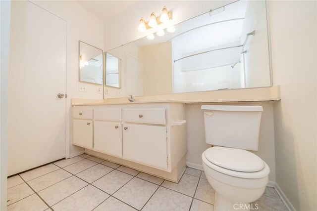 23607 Dracaea Ave, Moreno Valley, CA 92553 - bathroom featuring toilet, tile patterned flooring, vanity, and baseboards