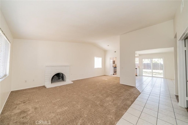23607 Dracaea Ave, Moreno Valley, CA 92553 - unfurnished living room featuring light tile patterned floors, light carpet, a fireplace, baseboards, and lofted ceiling