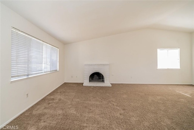 23607 Dracaea Ave, Moreno Valley, CA 92553 - unfurnished living room with healthy amount of natural light, carpet flooring, a fireplace, vaulted ceiling, and baseboards
