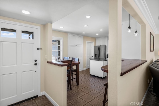 foyer entrance featuring baseboards and recessed lighting
