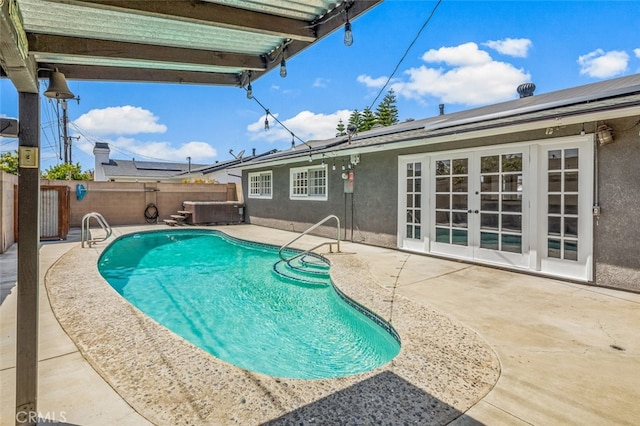 view of swimming pool featuring a fenced in pool, a patio, a fenced backyard, and french doors