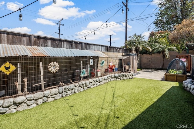 view of yard with fence, an outdoor structure, and a patio