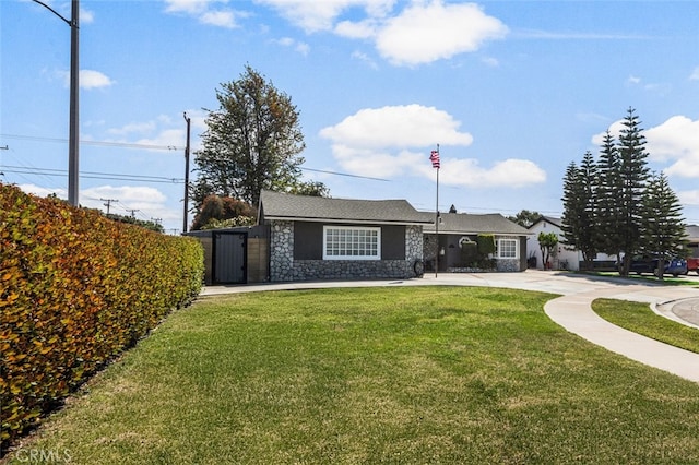 view of front of property with a front lawn and stone siding