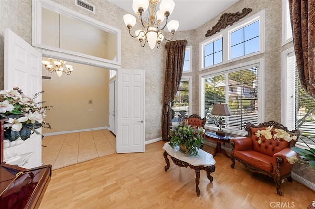 17265 Blue Spruce Ln, Yorba Linda, CA 92886 - sitting room featuring a chandelier, healthy amount of natural light, a towering ceiling, wood finished floors, and baseboards