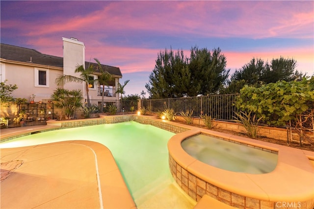 17265 Blue Spruce Ln, Yorba Linda, CA 92886 - pool at dusk featuring an in-ground hot tub and fence