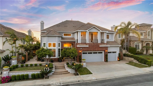 17265 Blue Spruce Ln, Yorba Linda, CA 92886 - view of front facade with driveway, an attached garage, brick siding, and a balcony