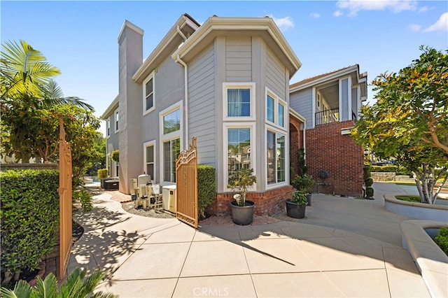 17265 Blue Spruce Ln, Yorba Linda, CA 92886 - view of side of home with a patio area and a chimney