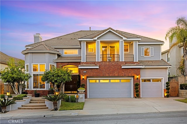 17265 Blue Spruce Ln, Yorba Linda, CA 92886 - view of front of property with a garage, concrete driveway, a chimney, a balcony, and brick siding