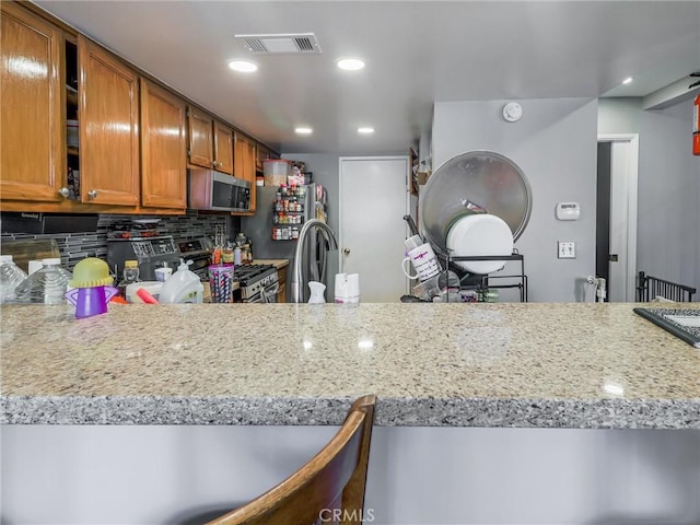 820 W Compton Blvd Unit 5, Compton, CA 90220 - kitchen with stainless steel appliances, brown cabinets, tasteful backsplash, recessed lighting, and a sink