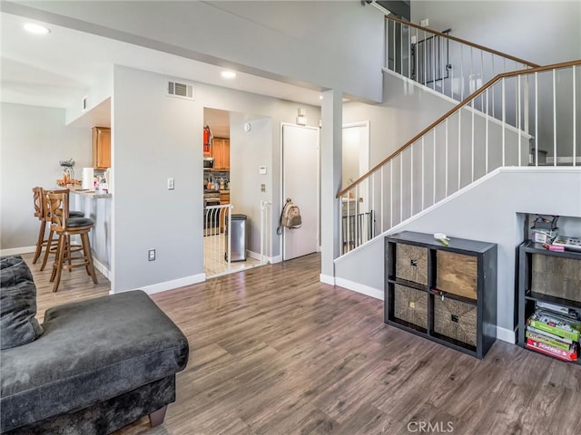 820 W Compton Blvd Unit 5, Compton, CA 90220 - living room with wood finished floors, stairs, baseboards, and recessed lighting