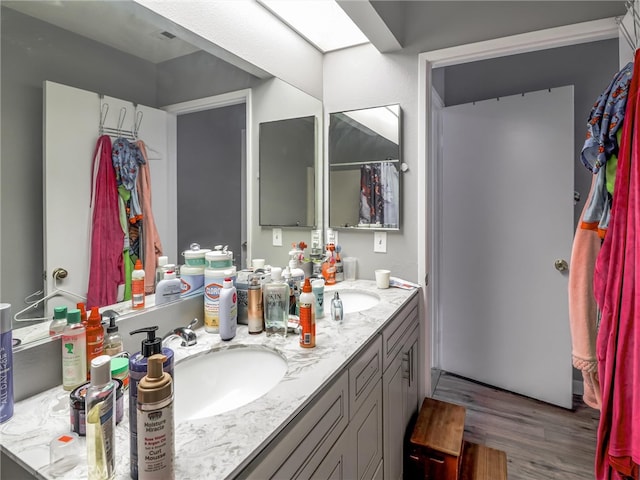 820 W Compton Blvd Unit 5, Compton, CA 90220 - bathroom with wood finished floors and double vanity
