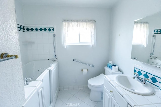 full bath with a combined bath / shower with jetted tub, toilet, tile patterned flooring, and vanity