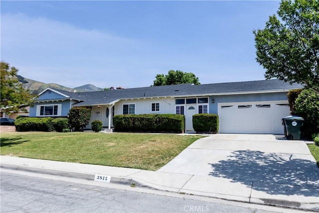 ranch-style home with driveway, a front yard, and a garage
