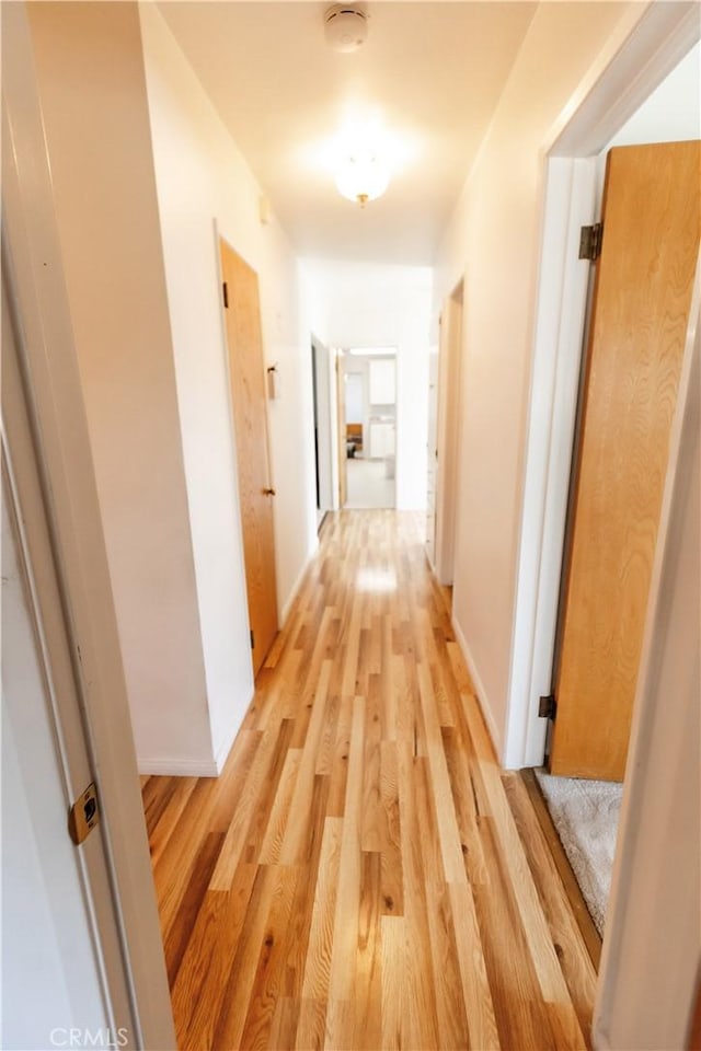corridor with light wood-style flooring