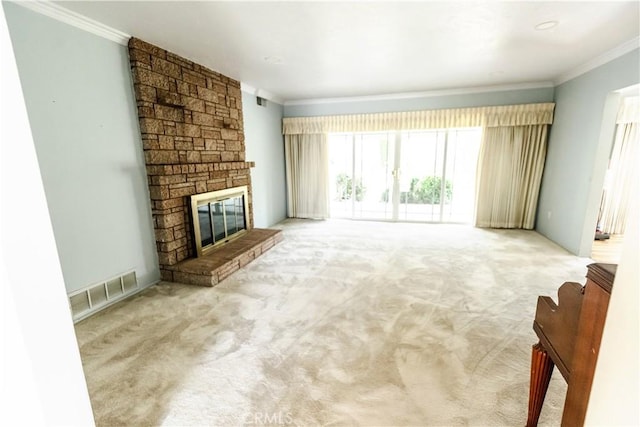 unfurnished living room with visible vents, a fireplace, carpet floors, and crown molding
