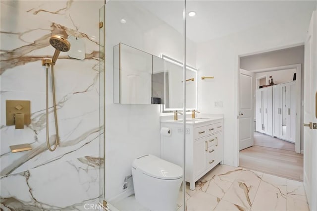 bathroom with marble finish floor, vanity, a marble finish shower, and toilet