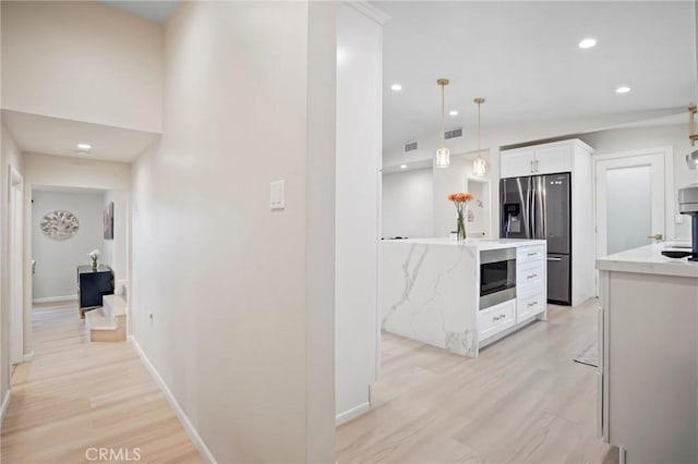 hall with light wood-style flooring, baseboards, recessed lighting, and vaulted ceiling