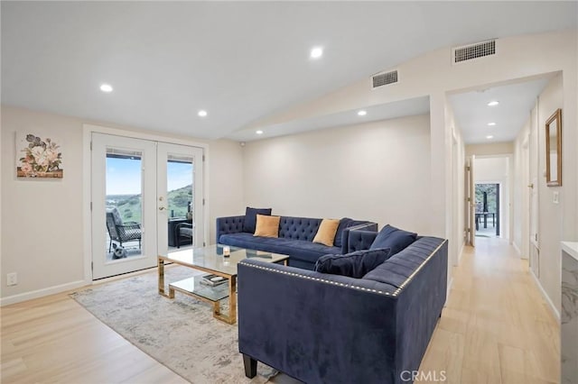living room featuring light wood finished floors, french doors, visible vents, and a healthy amount of sunlight