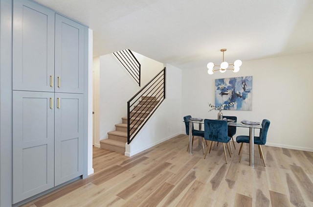 3906 Caminito Del Mar Surf, San Diego, CA 92130 - dining space with light wood-style flooring, a chandelier, and stairway