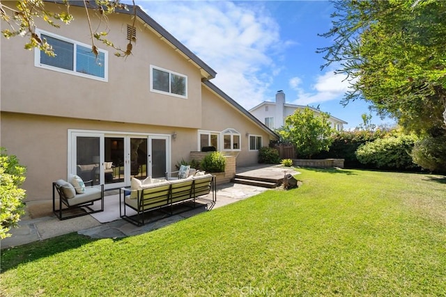 back of house featuring outdoor lounge area, fence, a yard, stucco siding, and a patio area