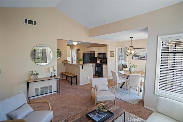 2327 Archwood Ln Unit 125, Simi Valley, CA 93063 - carpeted living area with an inviting chandelier, visible vents, a sink, and vaulted ceiling
