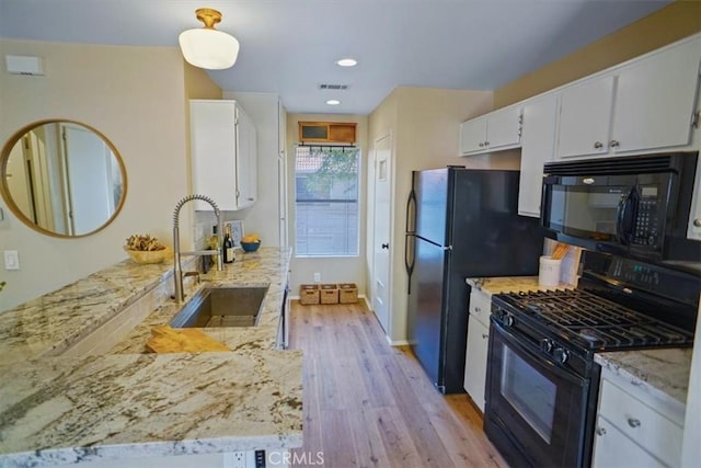 2327 Archwood Ln Unit 125, Simi Valley, CA 93063 - kitchen featuring a sink, white cabinetry, light stone countertops, black appliances, and light wood-style floors