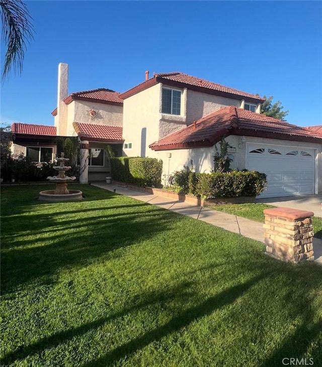 23680 Rhea Dr, Moreno Valley, CA 92557 - back of property featuring an attached garage, a tiled roof, stucco siding, and a lawn