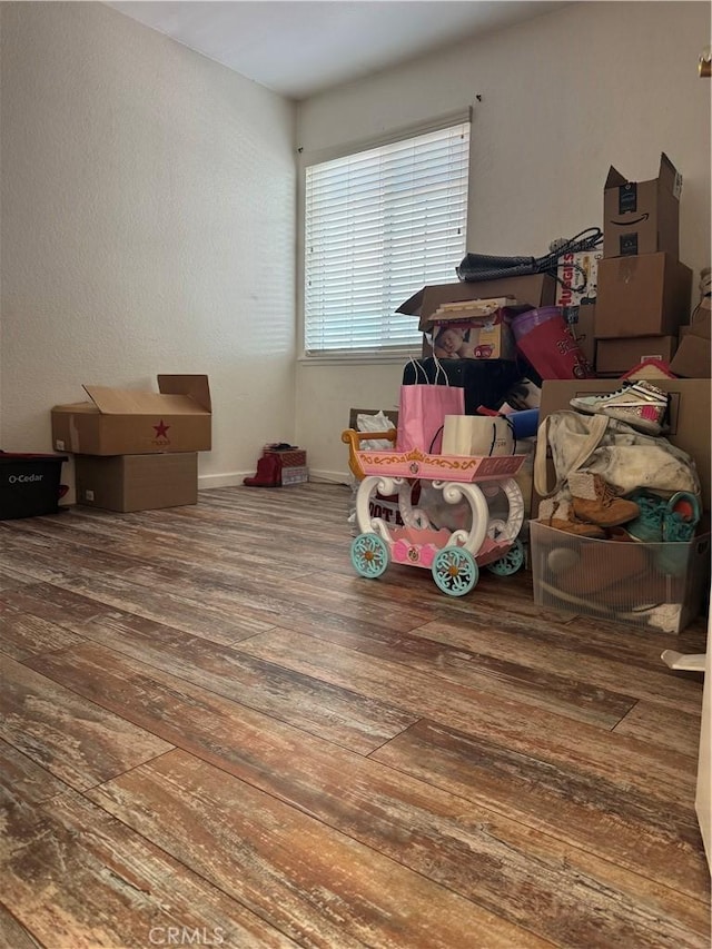 interior space with hardwood / wood-style floors and baseboards