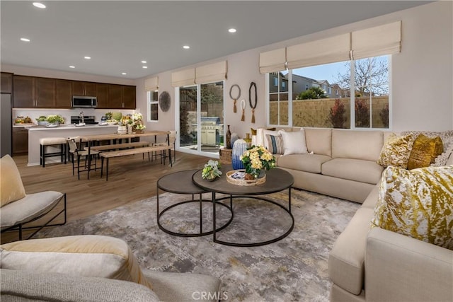 living area featuring light wood finished floors and recessed lighting
