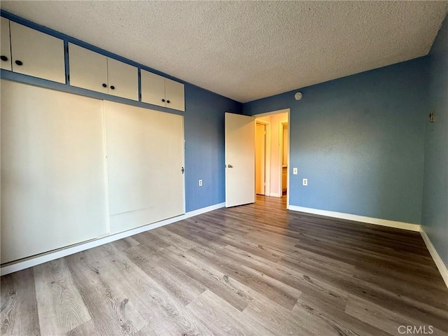 851 Ronda Mendoza Unit B, Laguna Woods, CA 92637 - unfurnished bedroom with wood finished floors and a textured ceiling