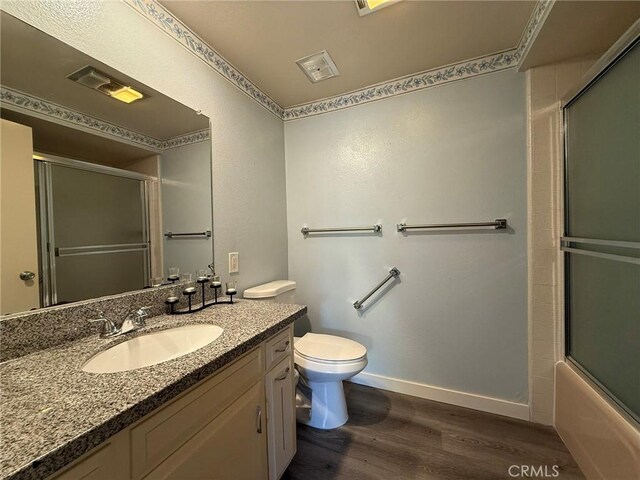 851 Ronda Mendoza Unit B, Laguna Woods, CA 92637 - full bathroom featuring wood finished floors, vanity, and enclosed tub / shower combo