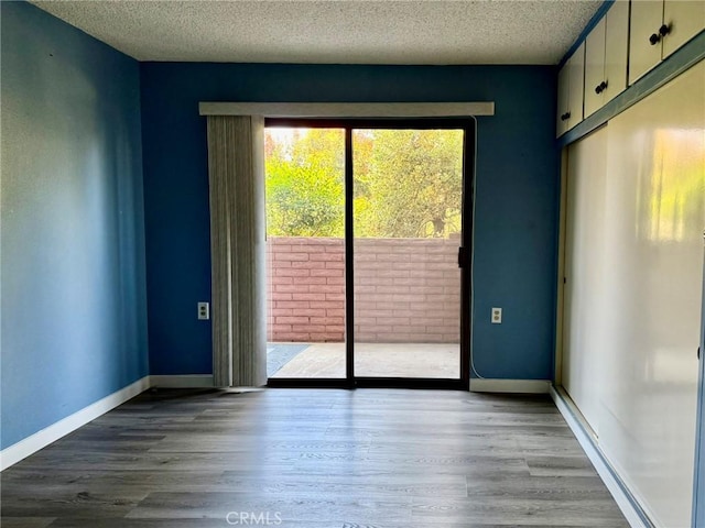 851 Ronda Mendoza Unit B, Laguna Woods, CA 92637 - spare room with a textured ceiling and wood finished floors