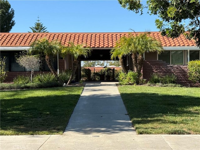 851 Ronda Mendoza Unit B, Laguna Woods, CA 92637 - view of front facade with a tile roof and a front lawn
