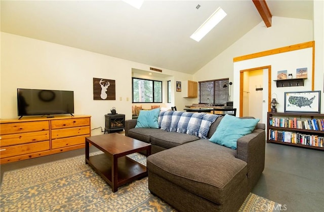 living area with beamed ceiling, visible vents, a wood stove, and high vaulted ceiling
