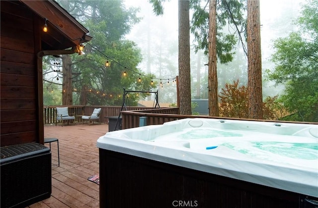 wooden deck with a hot tub