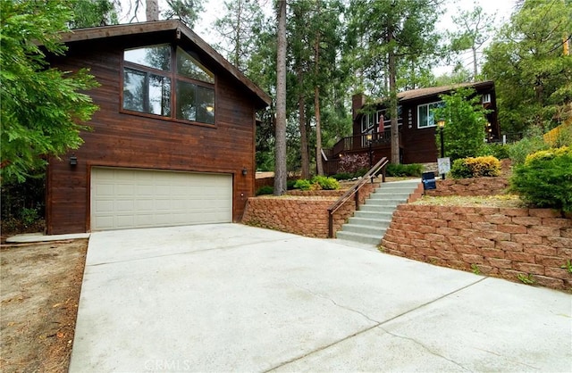 view of front of home with driveway, stairs, and a garage