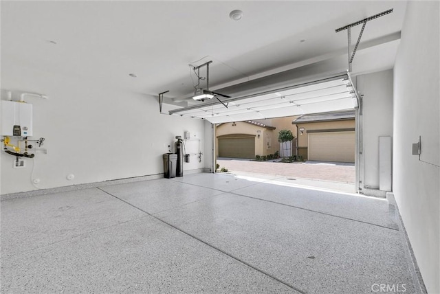 garage with a garage door opener and baseboards