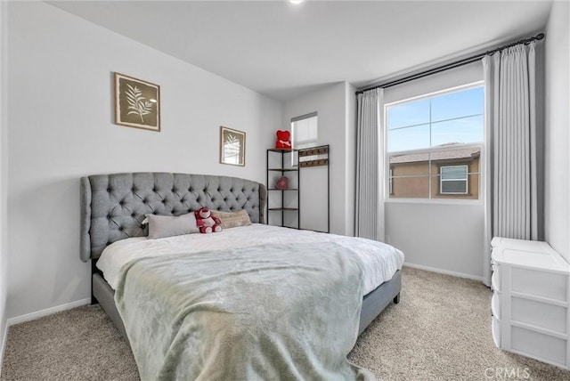 bedroom with baseboards and carpet floors
