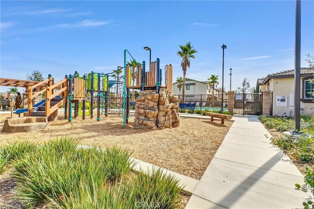 community playground featuring fence and a gate