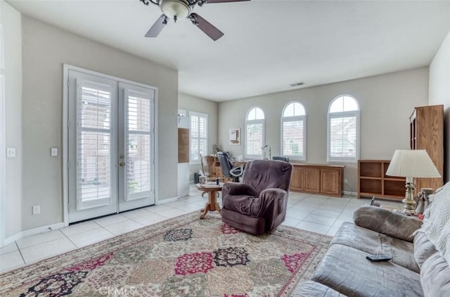 living room with light tile patterned flooring, visible vents, ceiling fan, and french doors