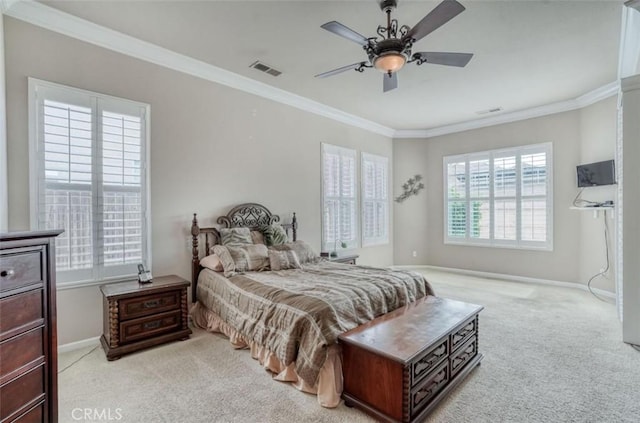 bedroom featuring baseboards, visible vents, light colored carpet, a ceiling fan, and crown molding
