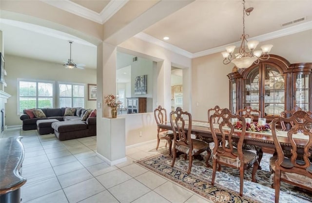 dining space with baseboards, visible vents, ceiling fan with notable chandelier, a high end fireplace, and light tile patterned floors