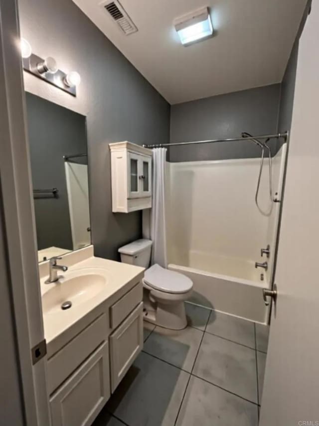 full bath with tile patterned floors, toilet, vanity, and shower / tub combo with curtain